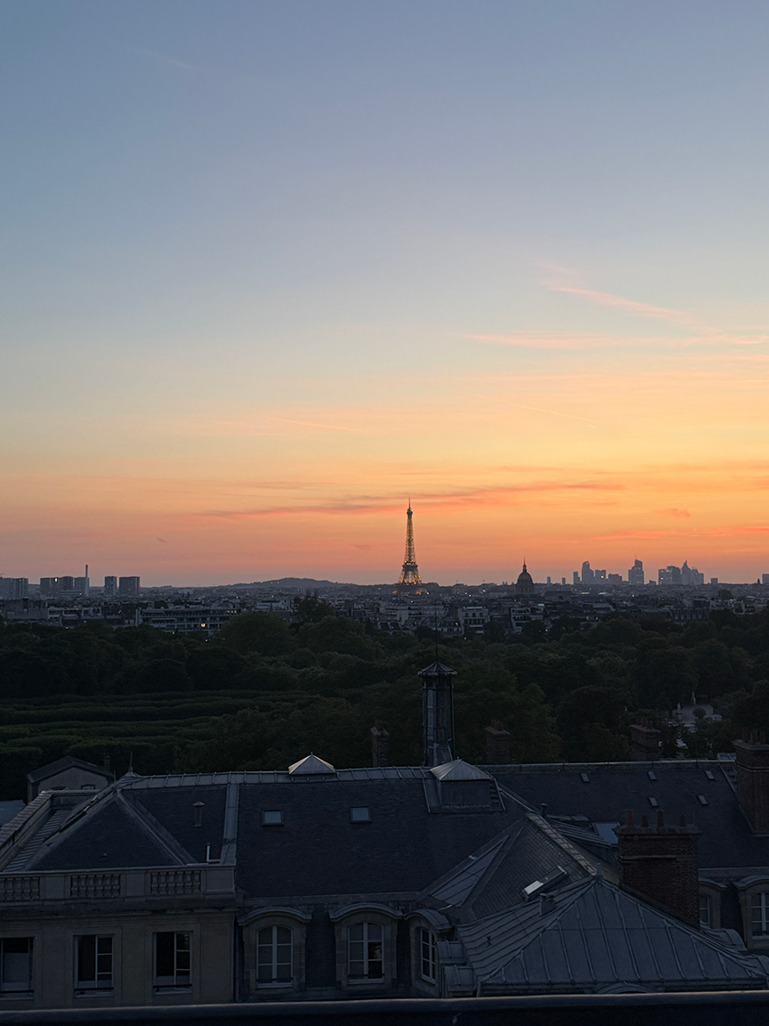 Skyline of Paris with the view of the Effiel Tower across an orange sky