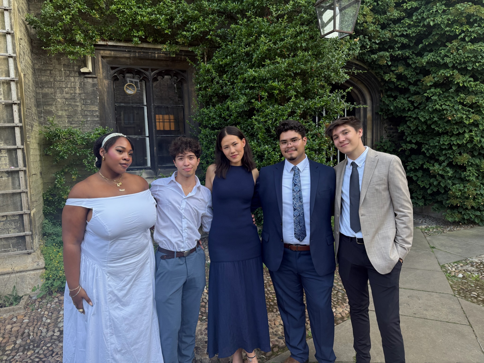 Oscar standing with friends at Cambridge