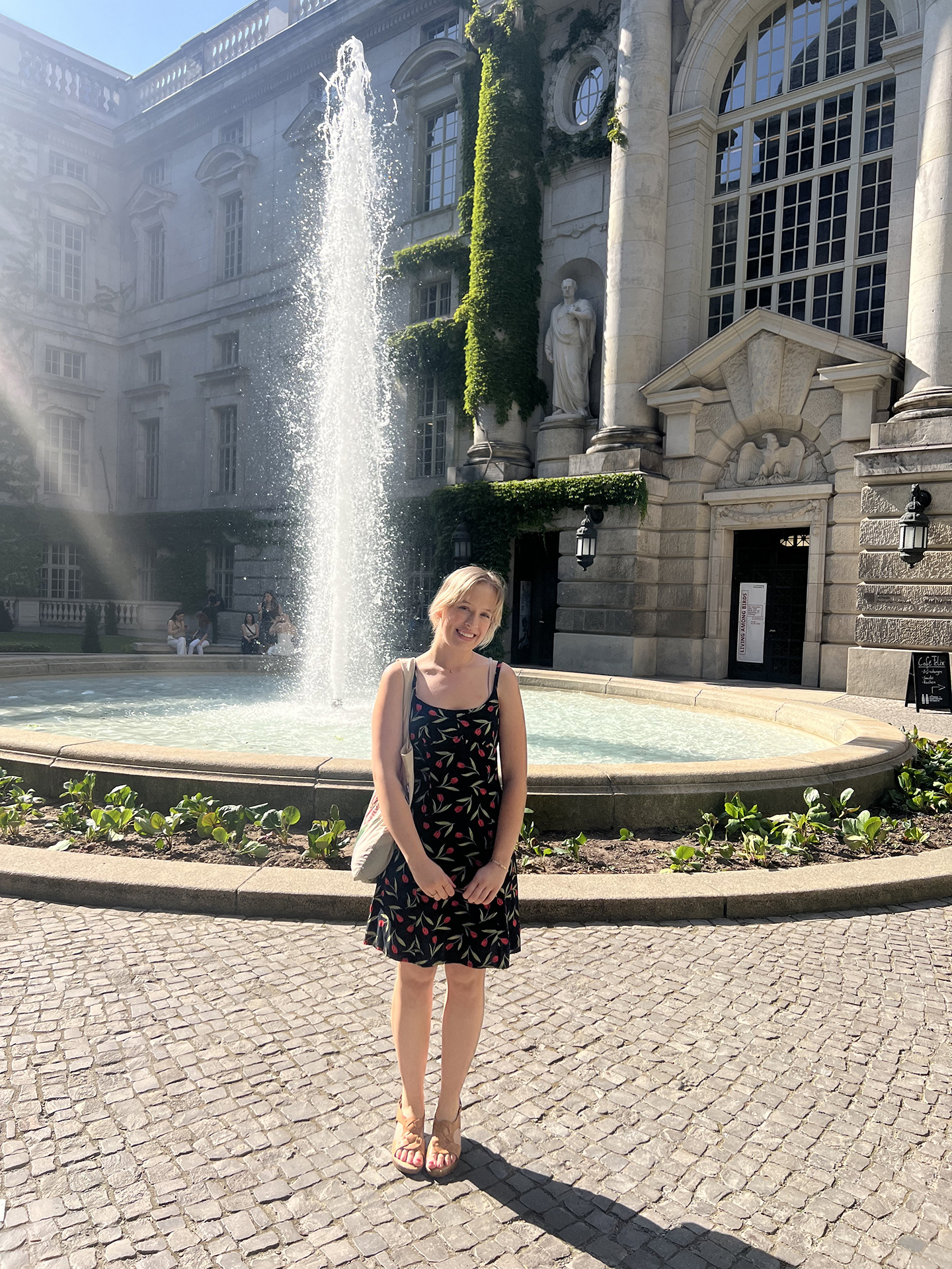 Ava standing in front of a fountain in Berlin
