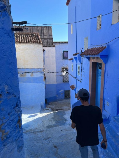 Amine walking through Chefchaouen, nicknamed the "Blue City," in Morocco