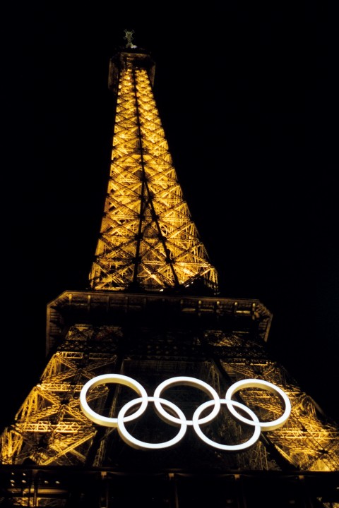 The Effiel Tower at night with the white Olympic rings during the Summer 2024