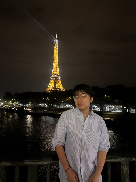Richie standing in front of the Effiel Tower 