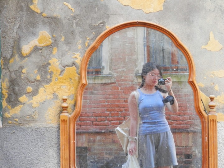 Cassie Wang taking a photo in a mirror