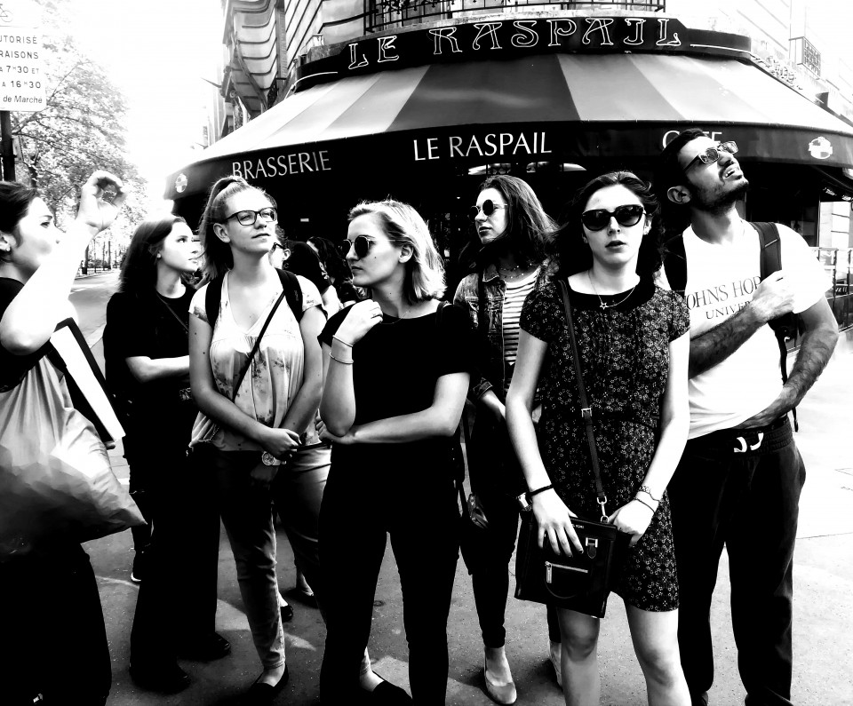 Learning about Montparnasse Black and white photo of students in Paris