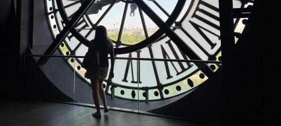 Reina standing inside a clock tower