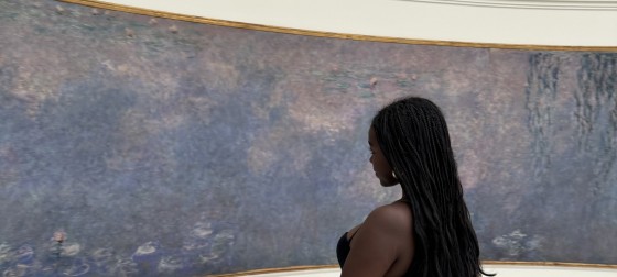 Maraki looking at an art piece by Monet