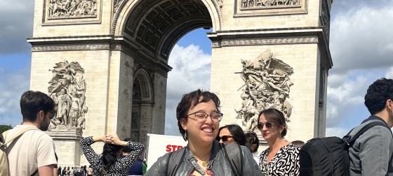 Imani standing in front of the Arc de Triomphe in Paris