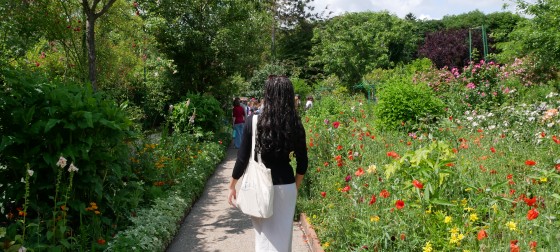 Yahney-Marie walking through a lush green garden