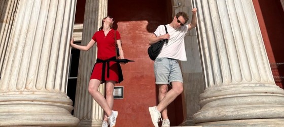Olivia Franklin and another student standing next to marble columns in Athens.
