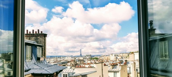 Looking out of a window in an apartment on Rue la Fayette in downtown Paris take by Isaiah Bekker on Unsplash 