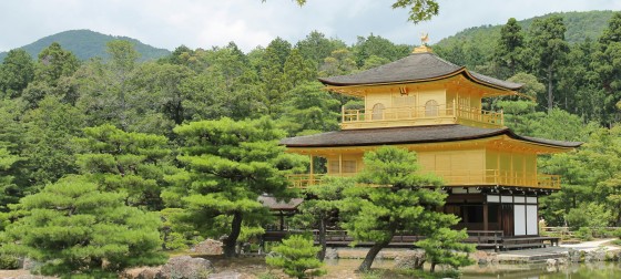 A large golden pavilion sitting in the middle of the trees
