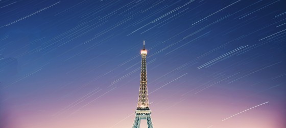 A time-lapse photo of the Eiffel Tower at sunset