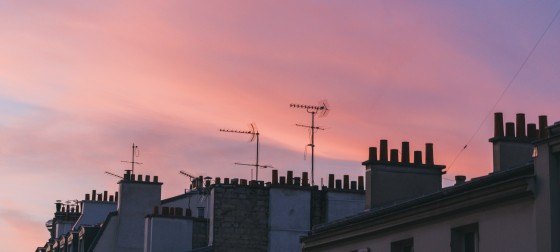 Tops of building in Paris as the sunsets taken by Remi Bertogliati on Unsplash