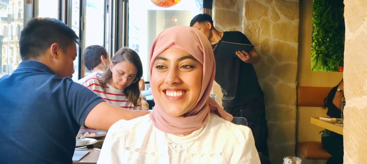 Hafsa Mohammed Abdul Samad sitting in a resturant smiling to the camera