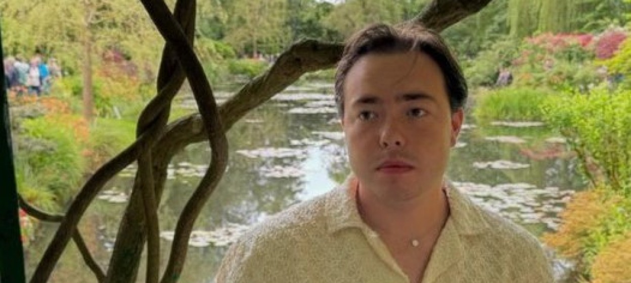 Crawford standing and looking off to the distance in a park