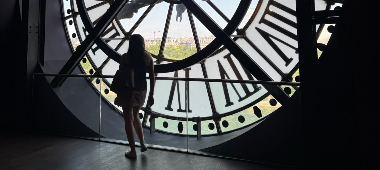 Reina standing inside a clock tower