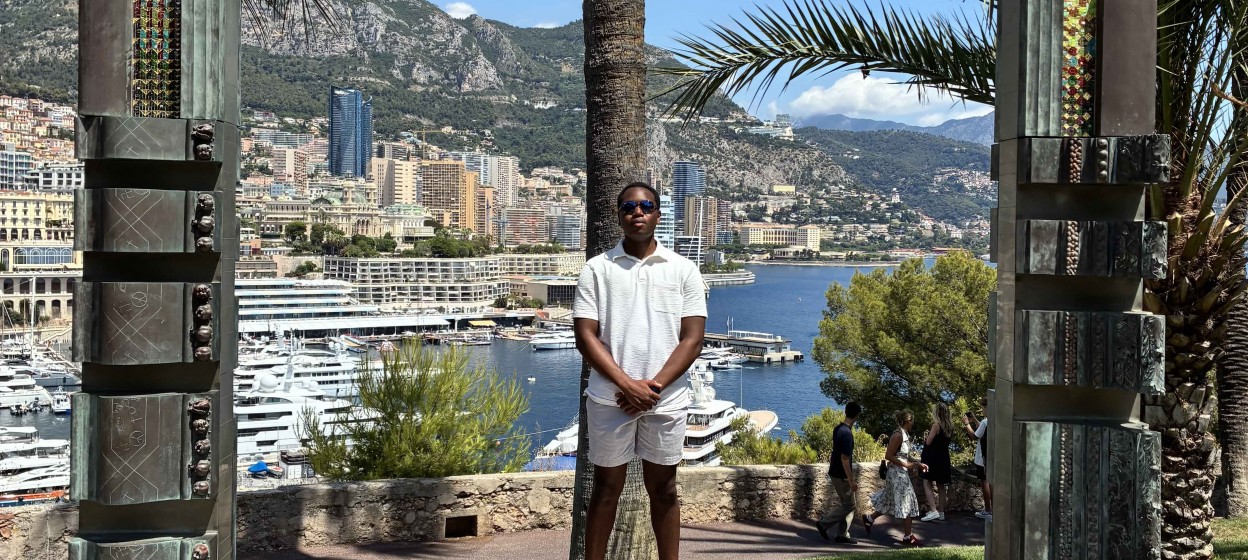 David standing within a frame overlooking the coast of Monaco 