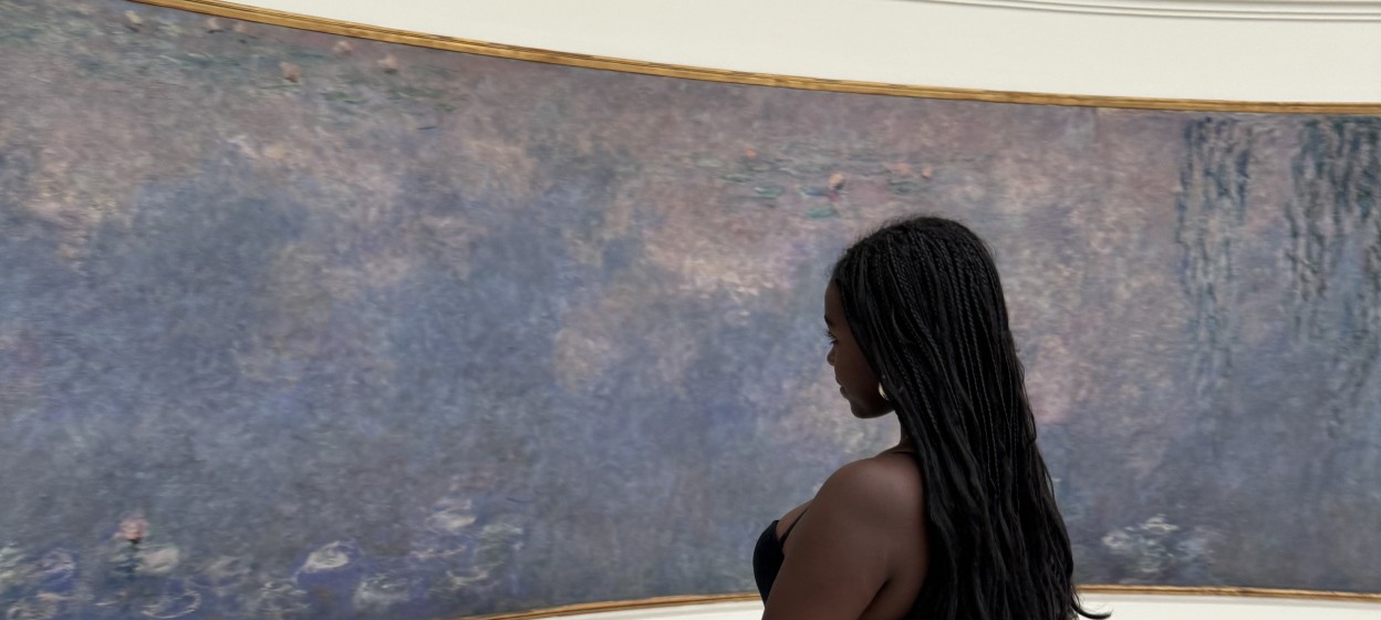Maraki looking at an art piece by Monet