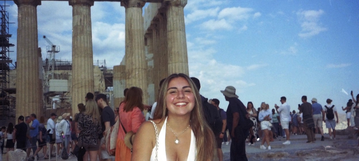 Regina standing in front of the acropolis in Athens, Greece