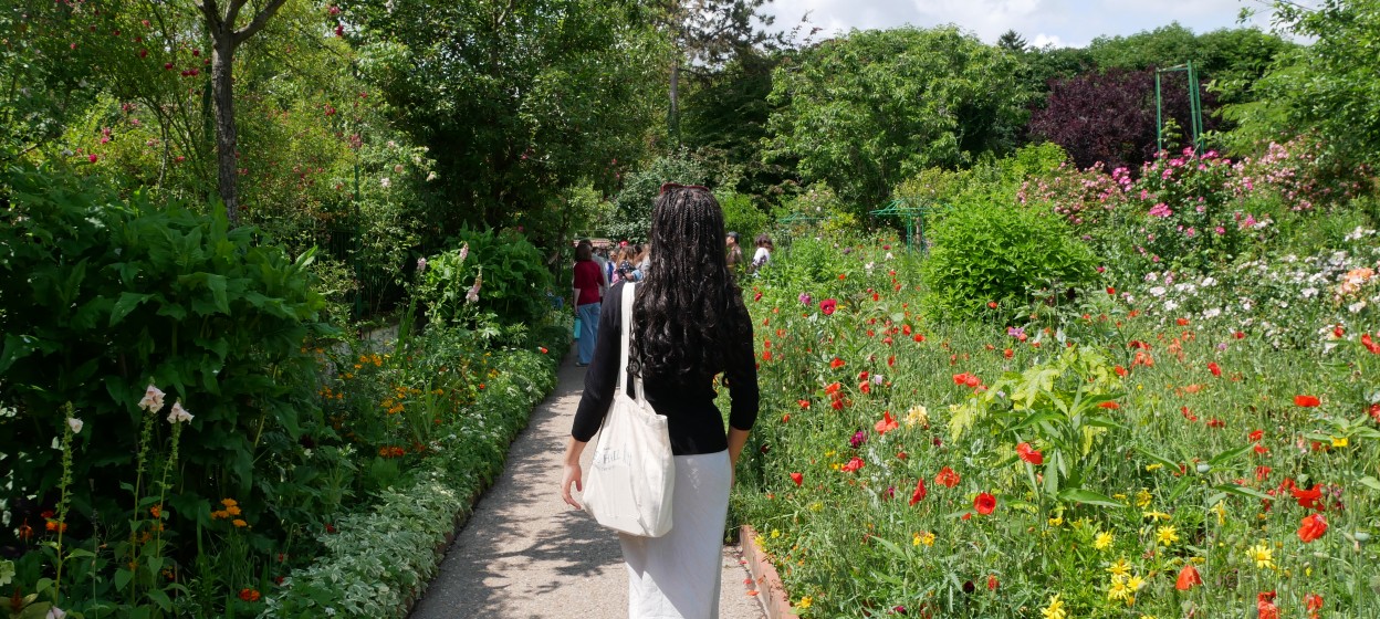 Yahney-Marie walking through a lush green garden