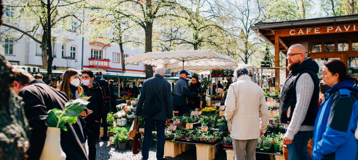 People walking through market in Berlin Friedrichshain, Germany taken by Christian Lue on Unsplash