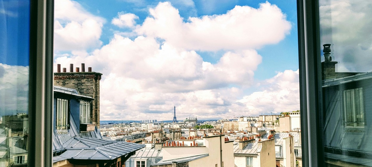 Looking out of a window in an apartment on Rue la Fayette in downtown Paris take by Isaiah Bekker on Unsplash 