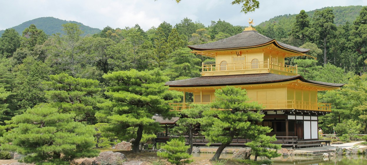 A large golden pavilion sitting in the middle of the trees