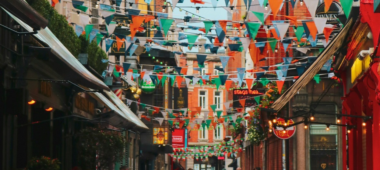 Street in Dublin with multicolored flags of Ireland during the daytime