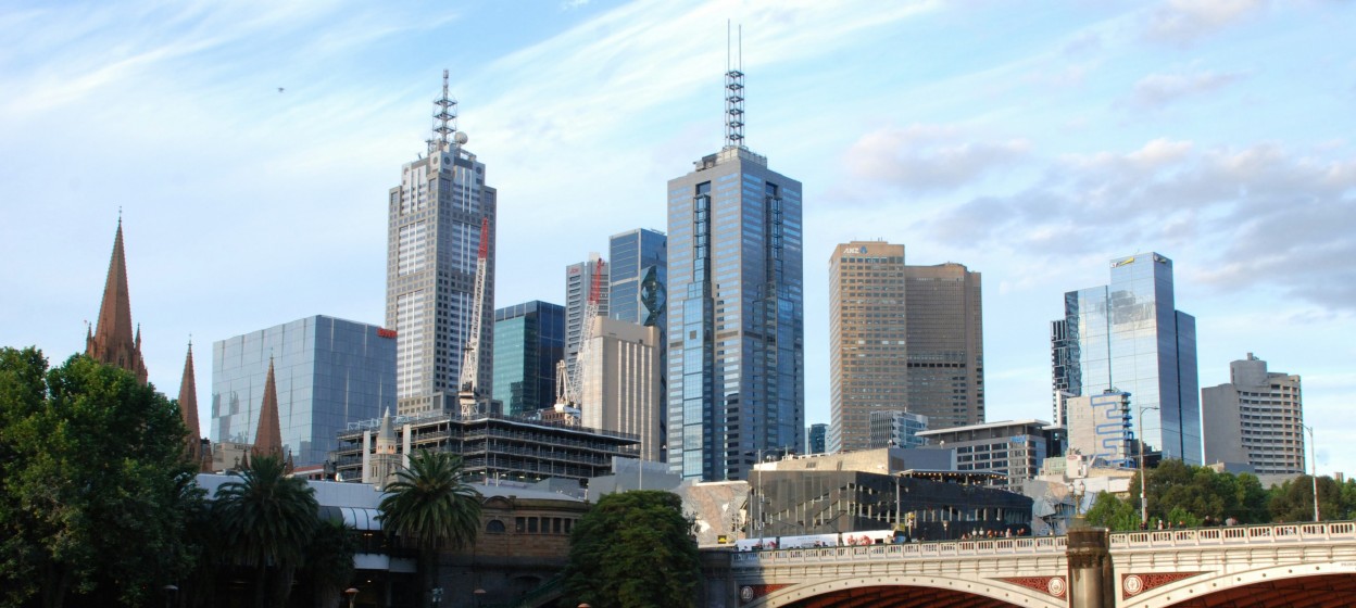 Brown bridge over river near city buildings during daytime in Melbourne
