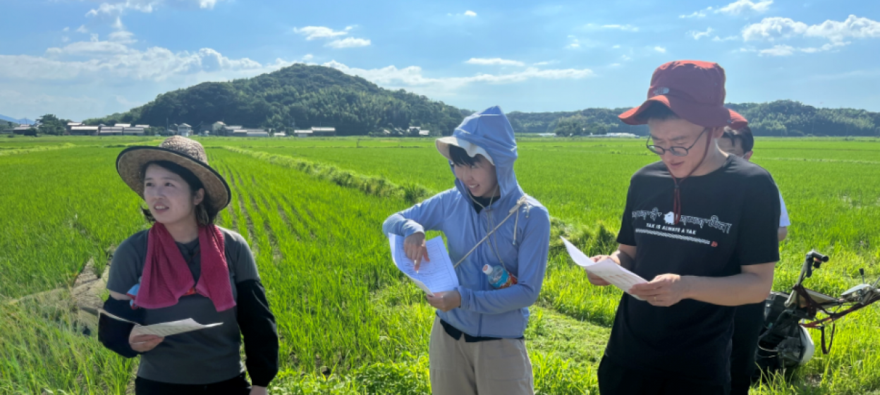 Students standing a field 