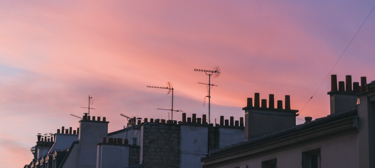 Tops of building in Paris as the sunsets taken by Remi Bertogliati on Unsplash
