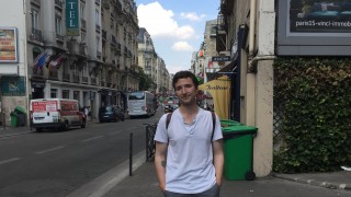 Male student standing on a street in Paris