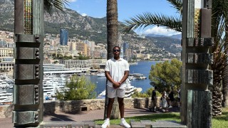 David standing within a frame overlooking the coast of Monaco