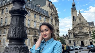 Katrina Rose Machett smiling to the camera in Paris