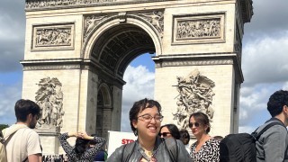 Imani standing in front of the Arc de Triomphe in Paris