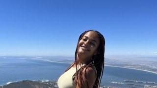 Esther standing at a lookout point viewing the Cape Town skyline and water