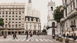 City street in Buenos Aries with white and light brown buildings.