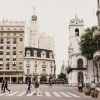 City street in Buenos Aries with white and light brown buildings.