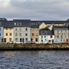 A row of houses in Galway next to a body of water
