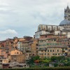 Skyline of church overlooking old city of Siena, Tuscany in Italy on a cloudy day