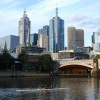 Brown bridge over river near city buildings during daytime in Melbourne