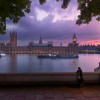 Person standing and looking out at the River Thames